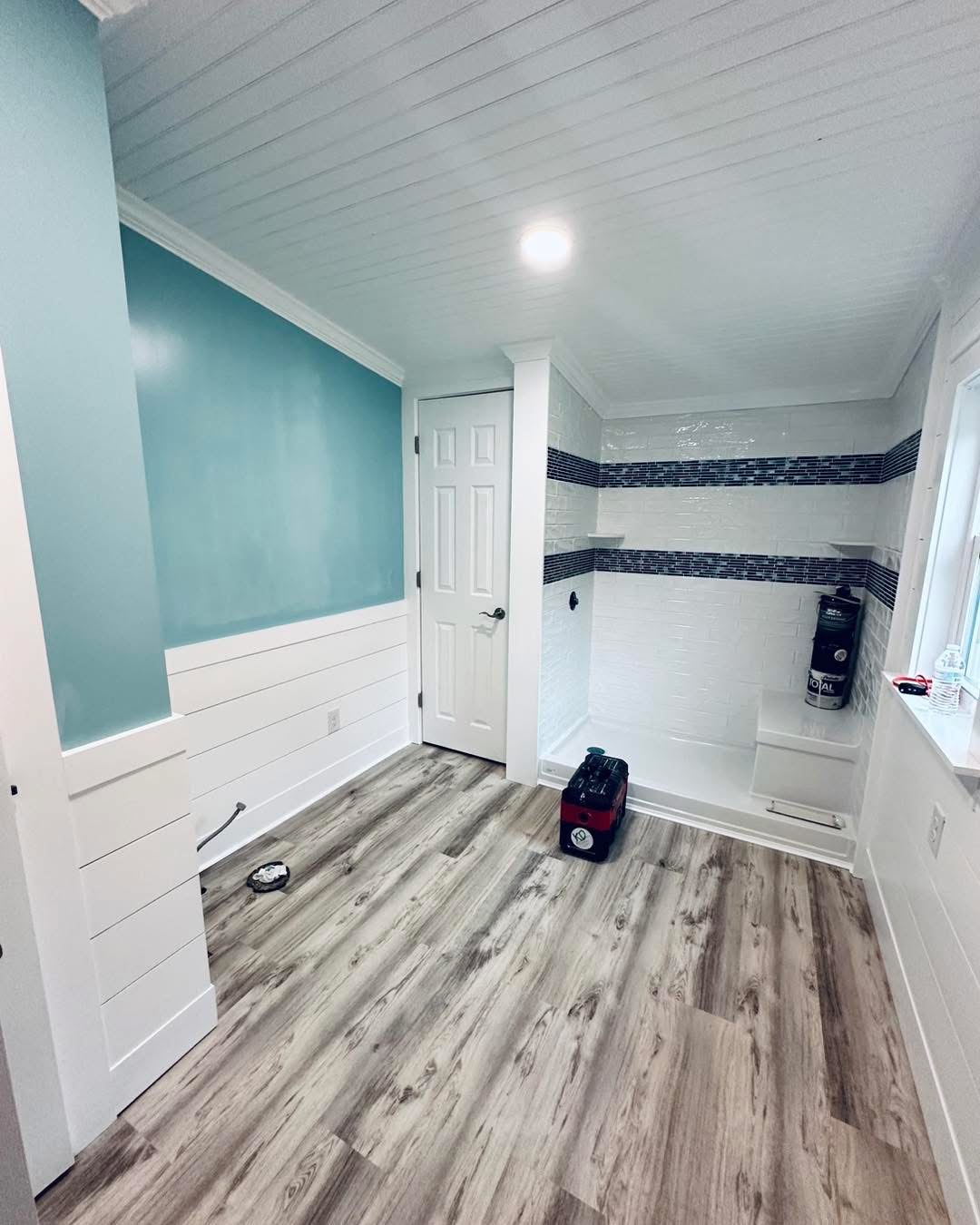 Bathhouse with teal accent wall and shiplap