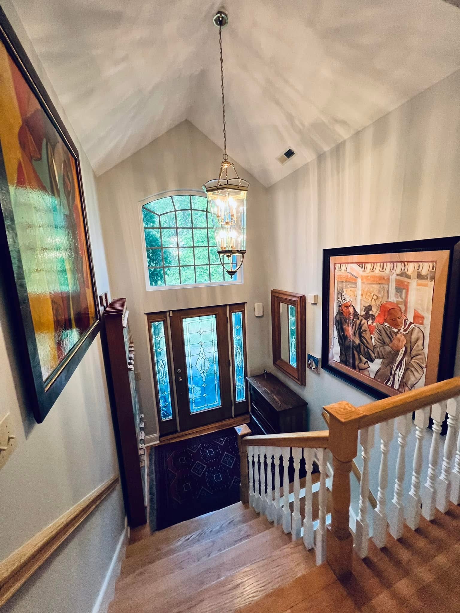 Foyer and staircase painting with vaulted ceiling