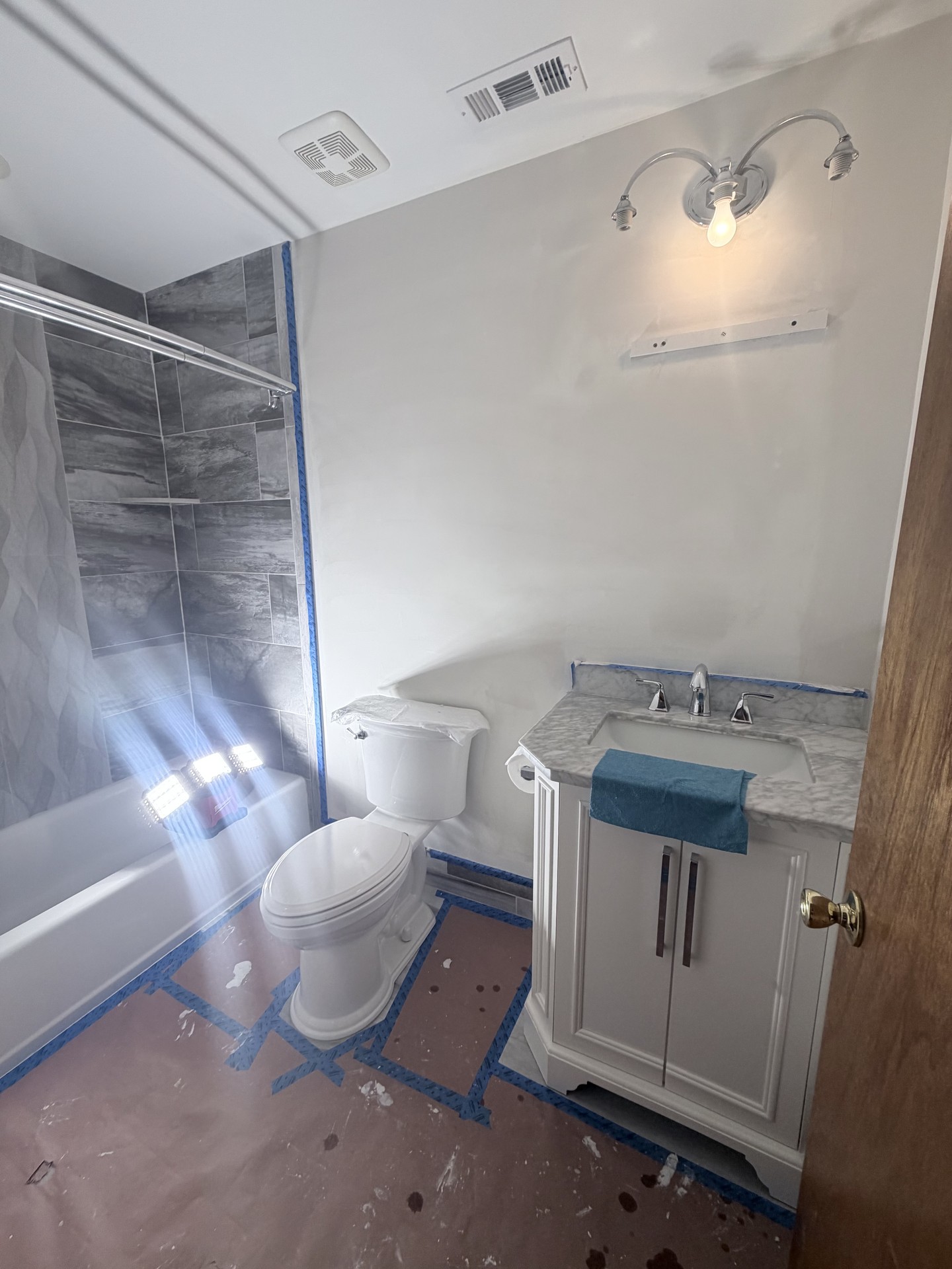 Ocean View bathroom during wall preparation with surfaces protected