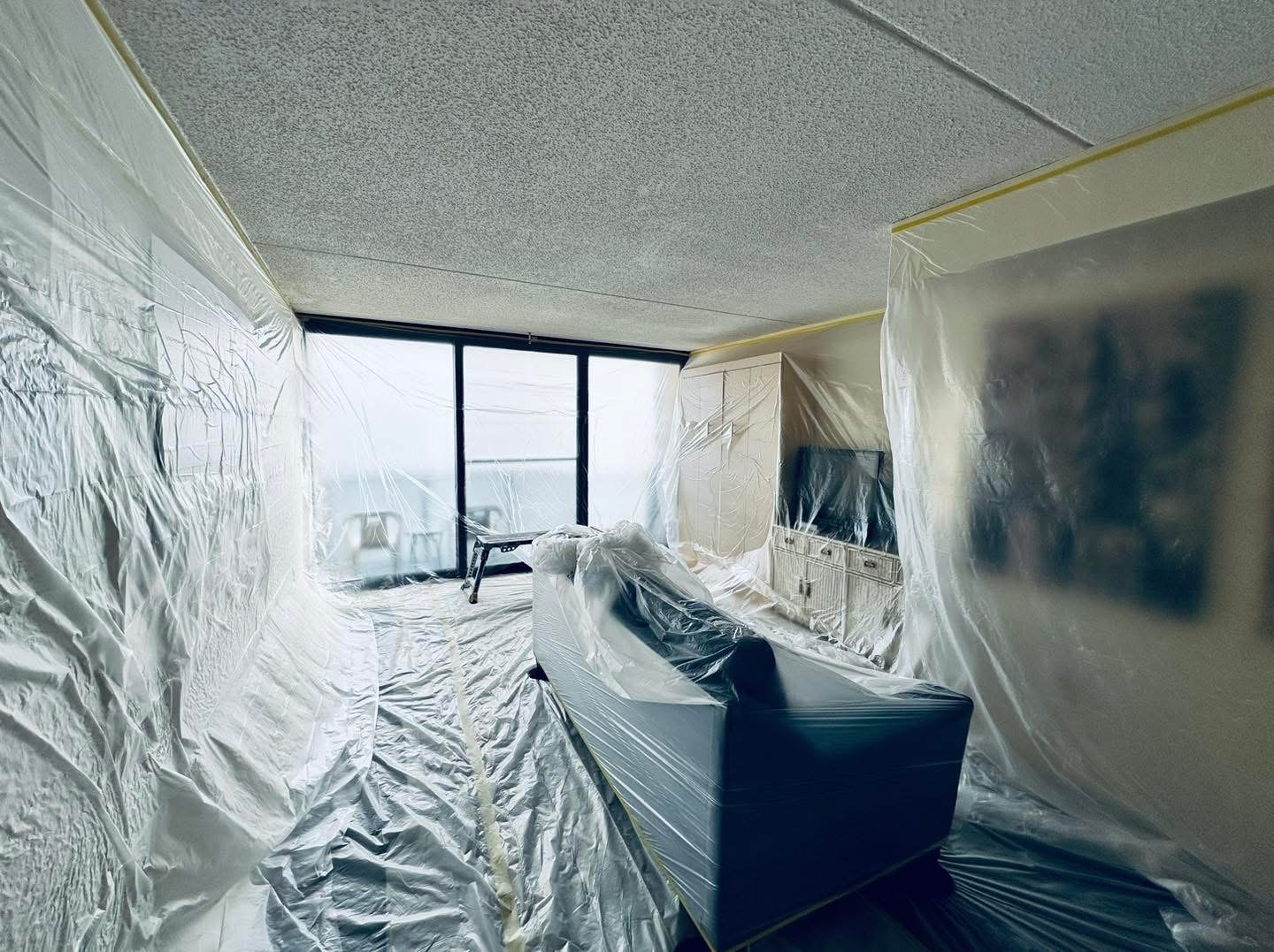 Oceanfront condo popcorn ceiling preparation with protected furnishings