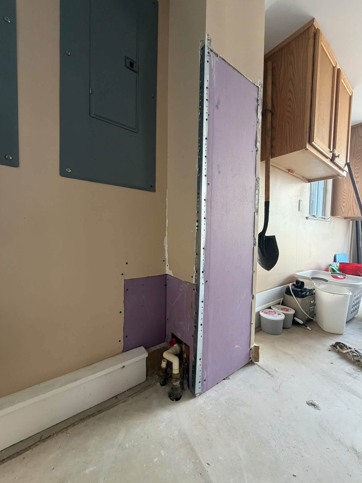 Replacement moisture-resistant drywall installed around the Rehoboth Beach plumbing access area